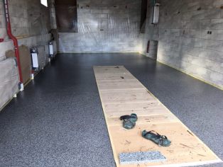 Waterproofing and laying the polymer floor in the garage with a basement