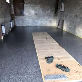 Waterproofing and laying the polymer floor in the garage with a basement
